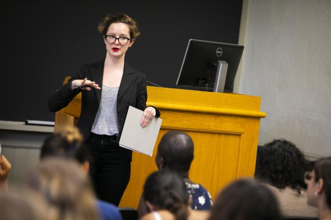 A professor lecturing a group of Harvard students