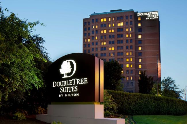 The Hilton DoubleTree Suites, illuminated in the early evening