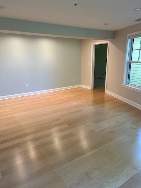 bedroom with large windows and wood floors