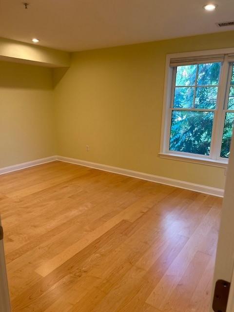 bedroom with large windows and wood floors