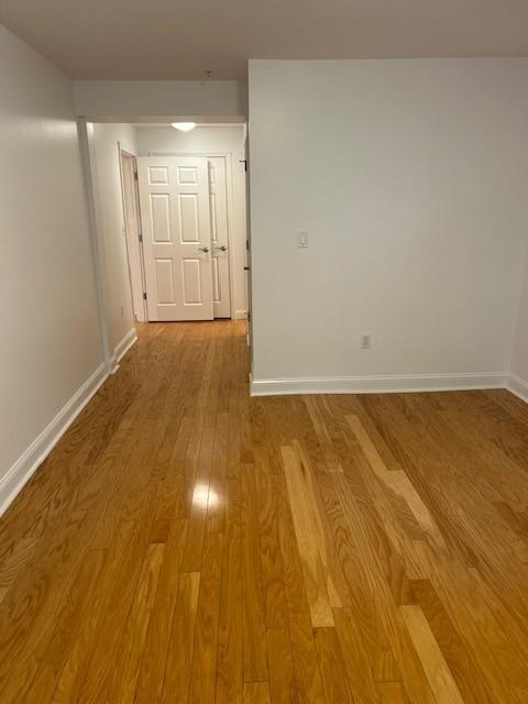 Primary bedroom with hardwood floors and a view of the door