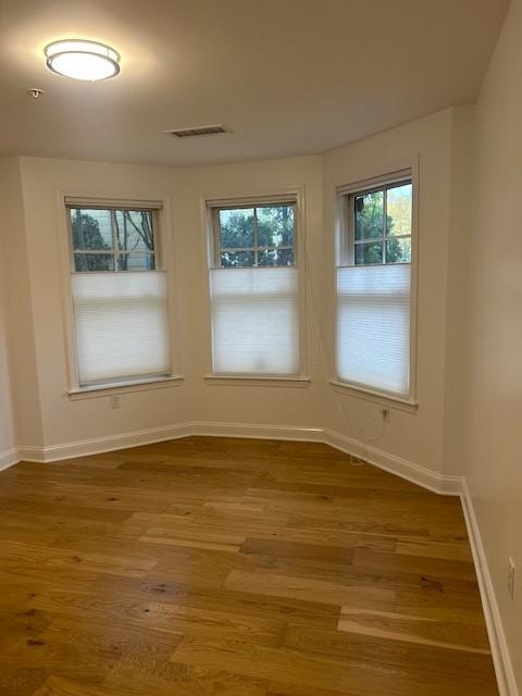 Secondary bedroom with bay windows and hard flooring