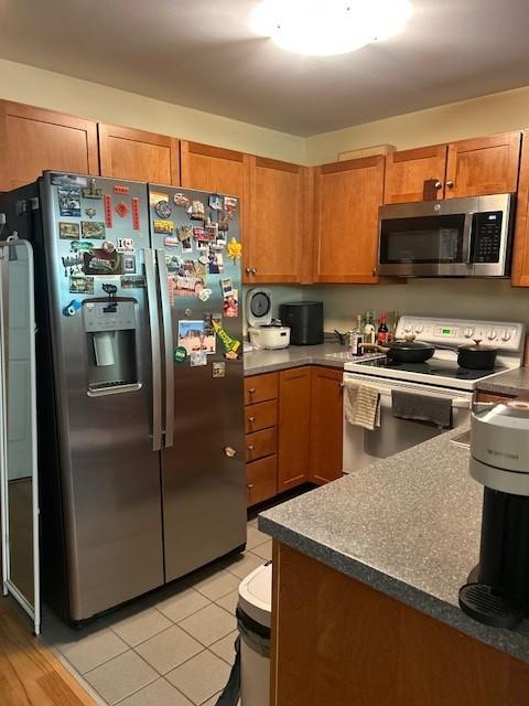 Kitchen with wood cabinetry and stainless steel appliances