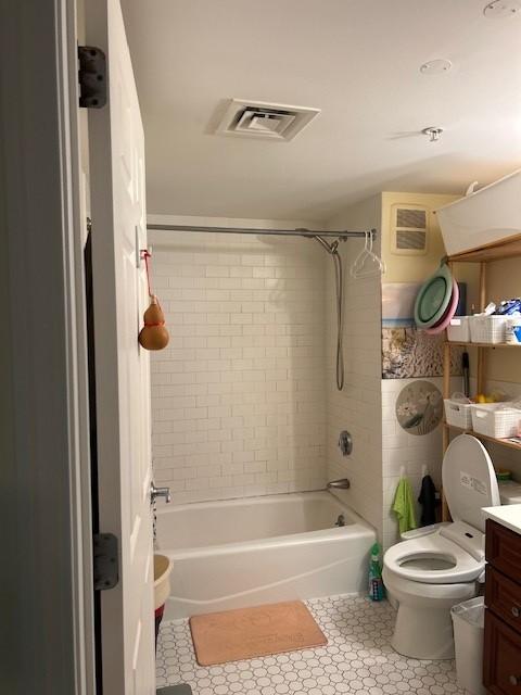 Bathroom with white tile flooring, shower/tub combo, vanity with sink and mirror