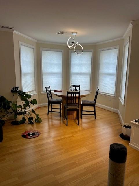 combined living and dining area with hard flooring and bay windows