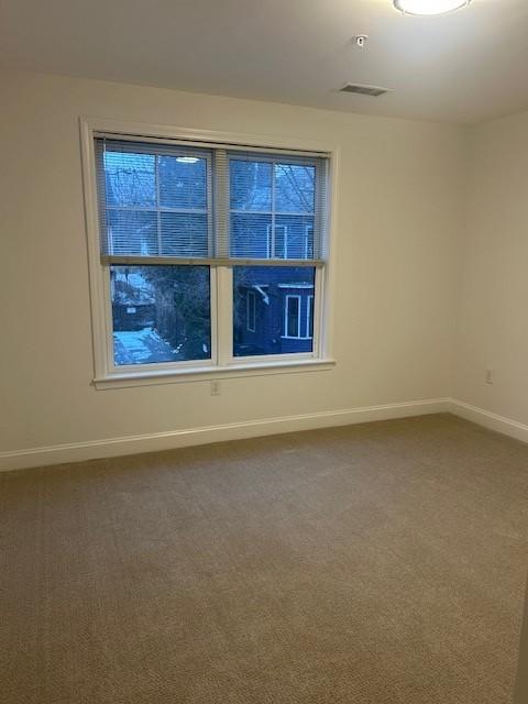 Second bedroom with carpeted flooring and large panel windows