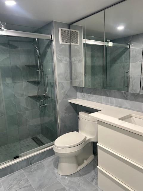 Primary bathroom with built in vanity and glass walk-in shower