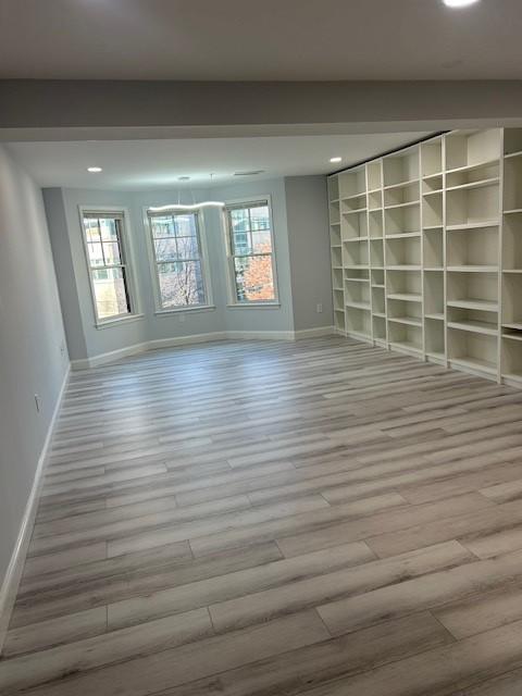 Living and dining area with bay windows and built in shelving