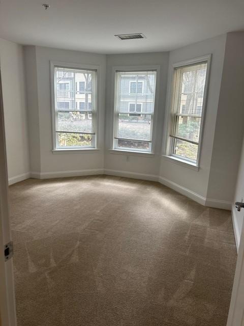 Bedroom with bay windows and carpeting