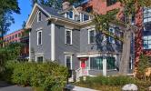 13 Kirkland: a newly renovated building with a bright red door and lush greenery