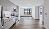 4 bedroom unit with view of living area and kitchen