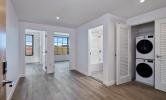 4 bedroom laundry closet with stacked washer and dryer